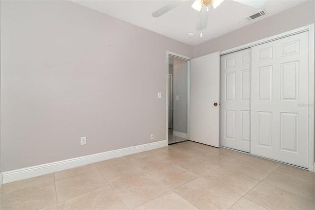 7058 Archwood Dr, Orlando, FL 32819 - unfurnished bedroom featuring light tile patterned floors, ceiling fan, baseboards, and a closet