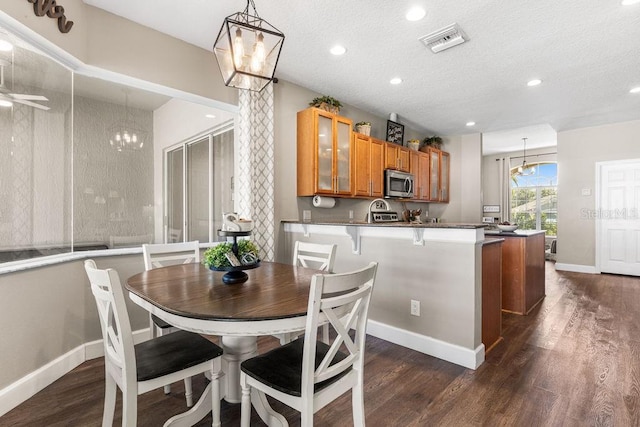 610 Strihal Loop, Oakland, FL 34787 - dining area featuring a chandelier, dark wood-style floors, recessed lighting, baseboards, and a textured ceiling