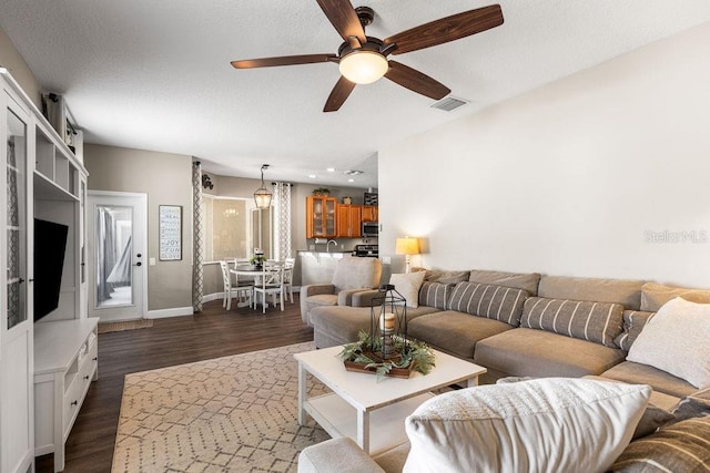 610 Strihal Loop, Oakland, FL 34787 - living room featuring dark wood-style floors, ceiling fan, and baseboards