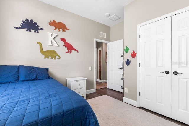 610 Strihal Loop, Oakland, FL 34787 - bedroom featuring wood finished floors, baseboards, and a closet