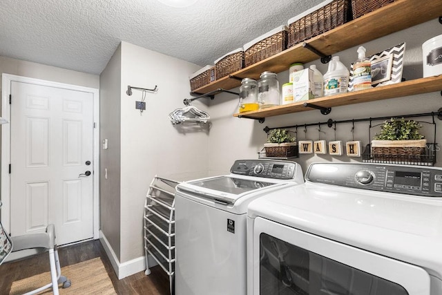 610 Strihal Loop, Oakland, FL 34787 - laundry room with washer and clothes dryer, wood finished floors, baseboards, and a textured ceiling