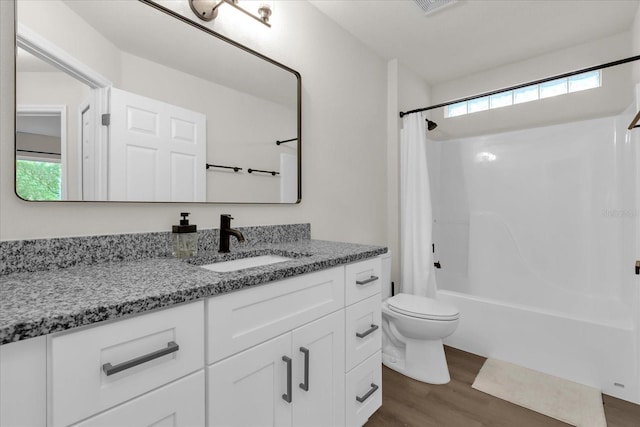 3622 Huntwicke Blvd, Davenport, FL 33837 - bathroom with vanity, toilet, wood finished floors, shower / tub combo, and healthy amount of natural light