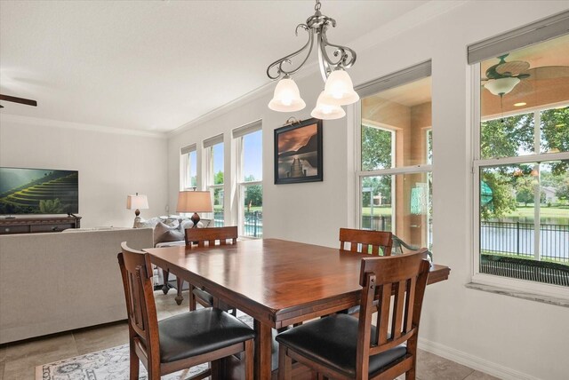 1613 Water Elm Ct, Orlando, FL 32825 - dining space featuring plenty of natural light, light tile patterned floors, ornamental molding, and baseboards