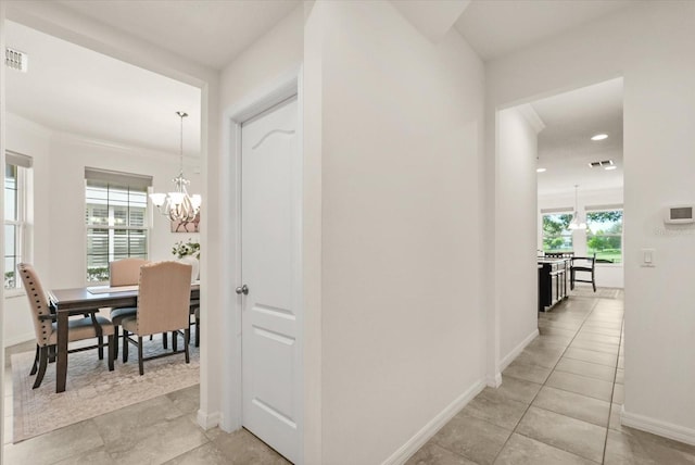 1613 Water Elm Ct, Orlando, FL 32825 - hallway with a chandelier, recessed lighting, baseboards, light tile patterned floors, and crown molding