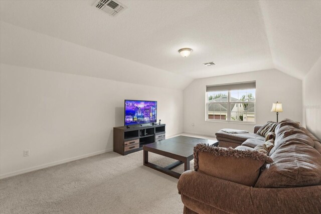 1613 Water Elm Ct, Orlando, FL 32825 - living room featuring vaulted ceiling, light carpet, and baseboards