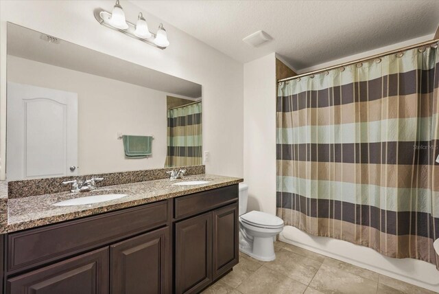 1613 Water Elm Ct, Orlando, FL 32825 - full bath featuring toilet, double vanity, tile patterned floors, and a textured ceiling