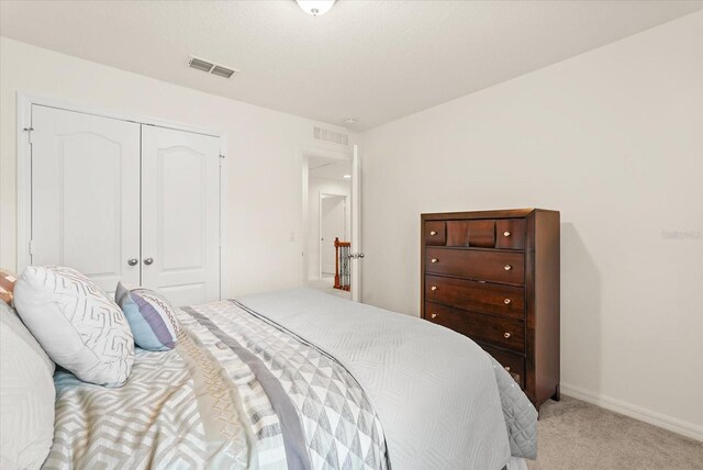 1613 Water Elm Ct, Orlando, FL 32825 - bedroom featuring light carpet, a closet, and baseboards