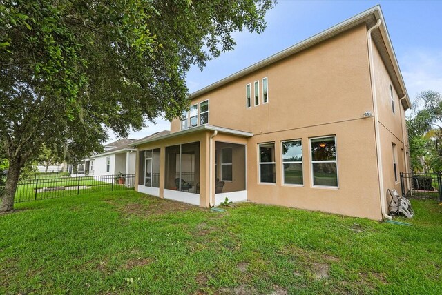 1613 Water Elm Ct, Orlando, FL 32825 - rear view of property featuring stucco siding and a sunroom