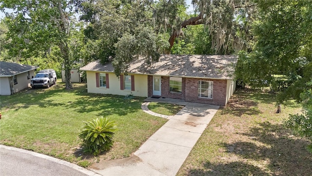 881 Cedar Cir, Tavares, FL 32778 - ranch-style home with a front yard, brick siding, driveway, and roof with shingles