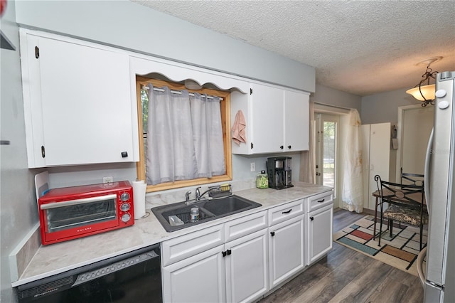 881 Cedar Cir, Tavares, FL 32778 - kitchen featuring a sink, freestanding refrigerator, black dishwasher, white cabinets, and dark wood-style floors