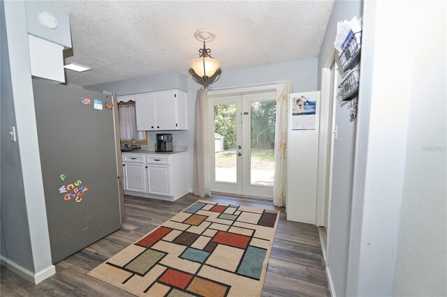 881 Cedar Cir, Tavares, FL 32778 - kitchen featuring french doors, white cabinetry, dark wood finished floors, and a textured ceiling