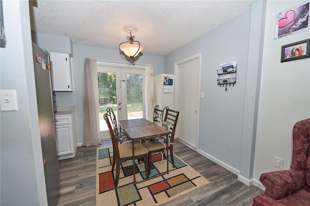 881 Cedar Cir, Tavares, FL 32778 - dining space featuring dark wood-style flooring, french doors, a textured ceiling, and baseboards