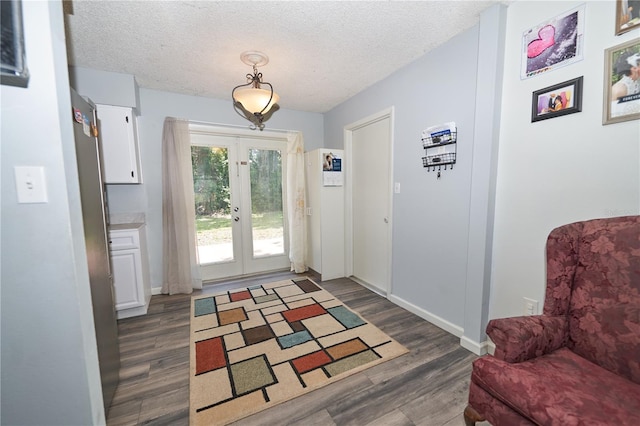 881 Cedar Cir, Tavares, FL 32778 - doorway with french doors, dark wood-style floors, a textured ceiling, and baseboards