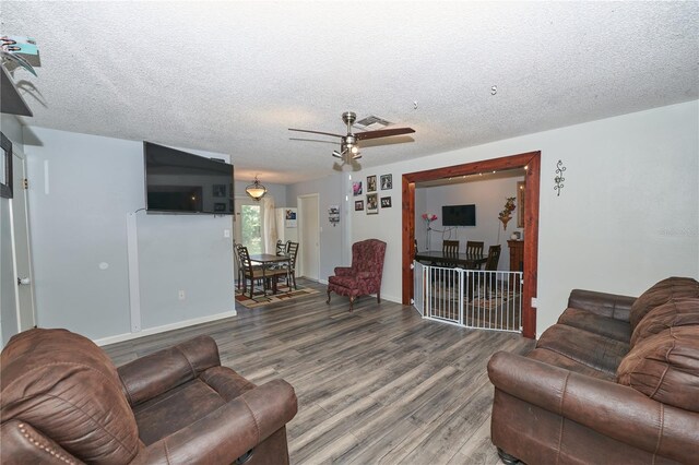 881 Cedar Cir, Tavares, FL 32778 - living room featuring wood finished floors, ceiling fan, a textured ceiling, and baseboards