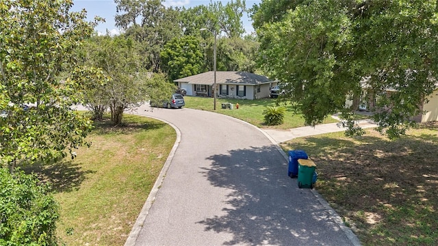 881 Cedar Cir, Tavares, FL 32778 - view of community featuring driveway and a yard