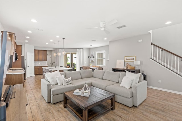 16013 Tollington Aly, Winter Garden, FL 34787 - living area featuring light wood-style flooring, recessed lighting, a ceiling fan, stairway, and baseboards