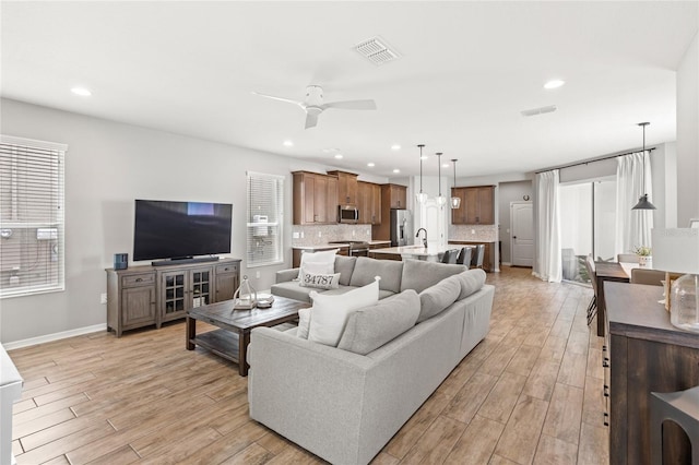 16013 Tollington Aly, Winter Garden, FL 34787 - living area featuring light wood-style floors, a ceiling fan, recessed lighting, and baseboards