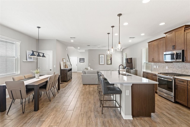 16013 Tollington Aly, Winter Garden, FL 34787 - kitchen with stainless steel appliances, a sink, light wood-style floors, and recessed lighting