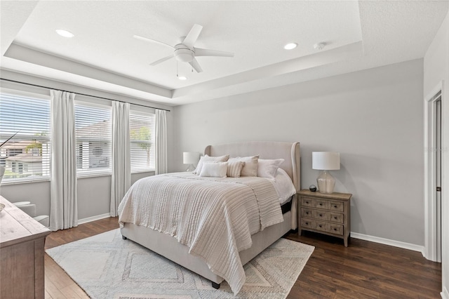 16013 Tollington Aly, Winter Garden, FL 34787 - bedroom with a raised ceiling, dark wood-style floors, baseboards, a ceiling fan, and recessed lighting