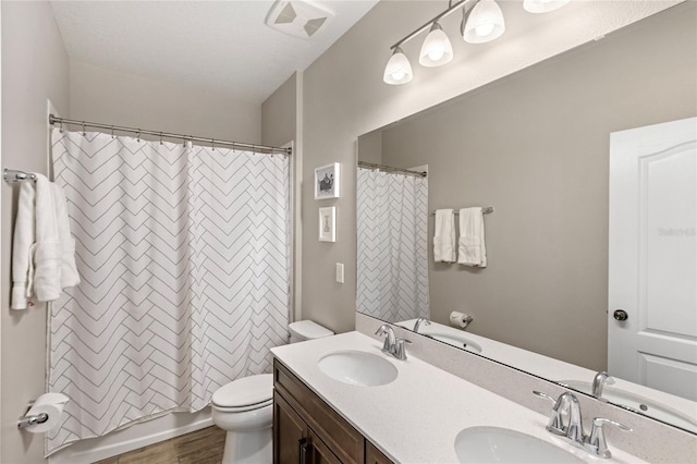 16013 Tollington Aly, Winter Garden, FL 34787 - full bathroom featuring toilet, double vanity, and wood finished floors