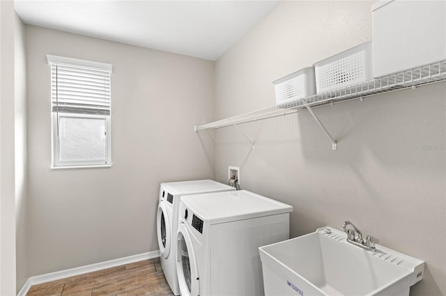 16013 Tollington Aly, Winter Garden, FL 34787 - laundry room with washing machine and dryer, light wood-style floors, and baseboards