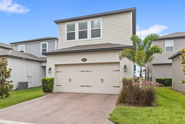16013 Tollington Aly, Winter Garden, FL 34787 - view of front of home with a garage, decorative driveway, a front lawn, and central AC