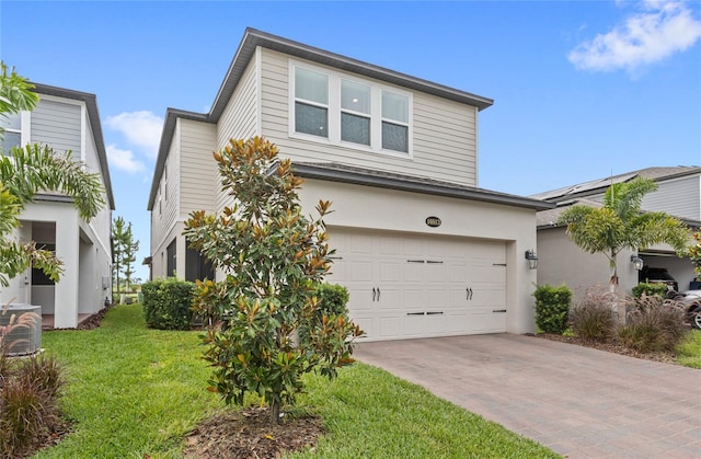 16013 Tollington Aly, Winter Garden, FL 34787 - view of front facade featuring driveway, a garage, a front yard, and stucco siding