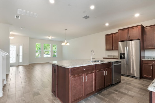 15477 Blackbead St, Winter Garden, FL 34787 - kitchen featuring stainless steel appliances, a sink, light wood-type flooring, light stone countertops, and recessed lighting