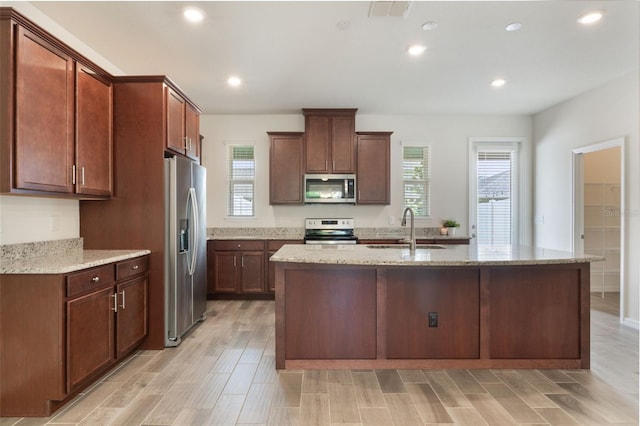 15477 Blackbead St, Winter Garden, FL 34787 - kitchen featuring stainless steel appliances, a sink, healthy amount of natural light, a center island with sink, and recessed lighting