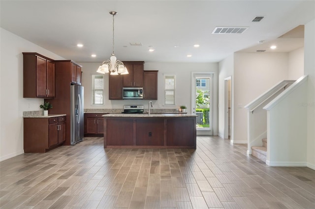 15477 Blackbead St, Winter Garden, FL 34787 - kitchen with appliances with stainless steel finishes, a chandelier, plenty of natural light, a sink, and recessed lighting