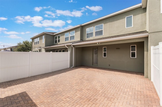 15477 Blackbead St, Winter Garden, FL 34787 - view of front facade with stucco siding, an attached garage, a patio area, and decorative driveway