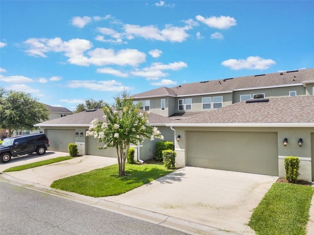 15477 Blackbead St, Winter Garden, FL 34787 - view of front of house featuring concrete driveway, stucco siding, a garage, and a shingled roof