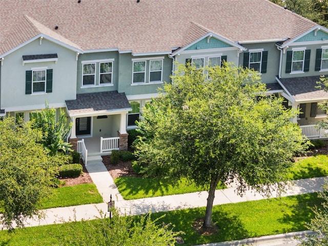 15477 Blackbead St, Winter Garden, FL 34787 - view of front facade featuring a shingled roof, stucco siding, and a porch