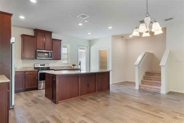 15477 Blackbead St, Winter Garden, FL 34787 - kitchen featuring stainless steel appliances, a chandelier, a center island, a sink, and recessed lighting