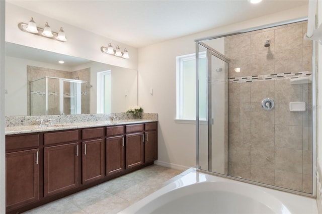 15477 Blackbead St, Winter Garden, FL 34787 - full bathroom with a shower stall, double vanity, a bath, baseboards, and tile patterned flooring