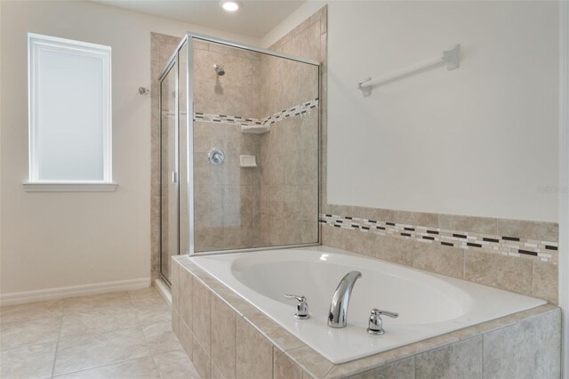15477 Blackbead St, Winter Garden, FL 34787 - bathroom featuring a bath, a shower stall, baseboards, and tile patterned flooring