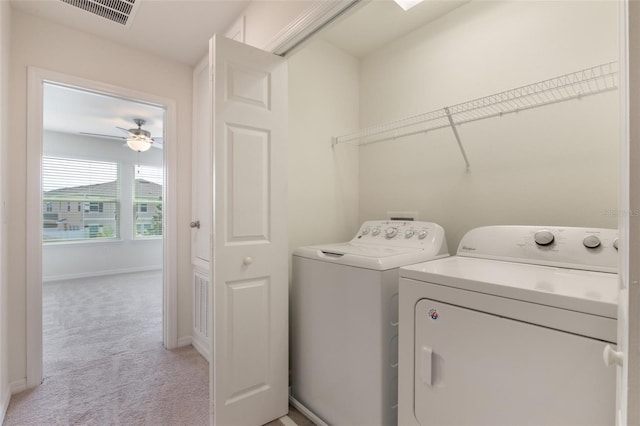 15477 Blackbead St, Winter Garden, FL 34787 - laundry room with independent washer and dryer, light colored carpet, a ceiling fan, and baseboards