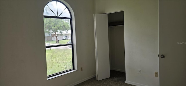 2008 Juniper Dr, Edgewater, FL 32141 - unfurnished bedroom featuring a closet, baseboards, and dark carpet