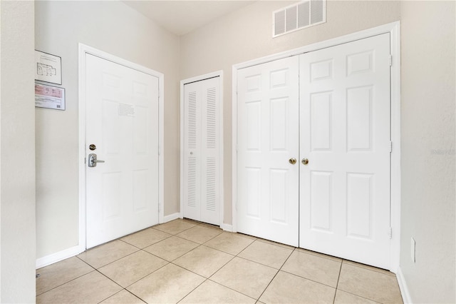 2821 Almaton Loop Unit 105, Kissimmee, FL 34747 - entrance foyer featuring light tile patterned floors and baseboards