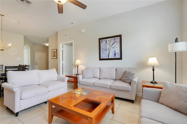 2821 Almaton Loop Unit 105, Kissimmee, FL 34747 - living room featuring light tile patterned floors, a ceiling fan, arched walkways, and a chandelier