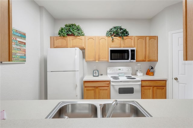 2821 Almaton Loop Unit 105, Kissimmee, FL 34747 - kitchen with white appliances, a sink, light countertops, and light brown cabinets