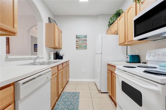 2821 Almaton Loop Unit 105, Kissimmee, FL 34747 - kitchen featuring white appliances, light brown cabinetry, a sink, and light countertops