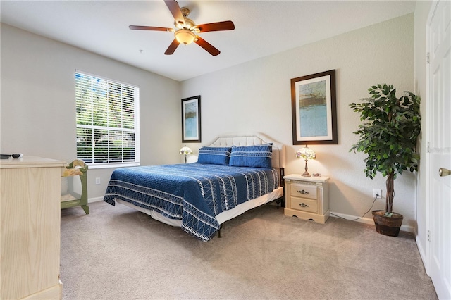 2821 Almaton Loop Unit 105, Kissimmee, FL 34747 - bedroom with baseboards, light carpet, and ceiling fan