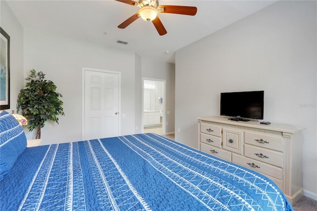 2821 Almaton Loop Unit 105, Kissimmee, FL 34747 - bedroom with baseboards, a ceiling fan, and connected bathroom