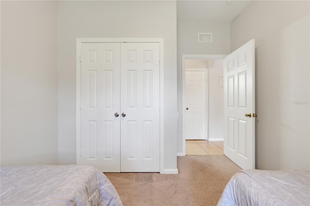 2821 Almaton Loop Unit 105, Kissimmee, FL 34747 - bedroom with carpet flooring, a closet, and baseboards