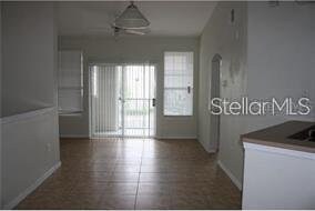 1101 Vintage Village Ln Unit 106, Ocoee, FL 34761 - hall featuring arched walkways and baseboards
