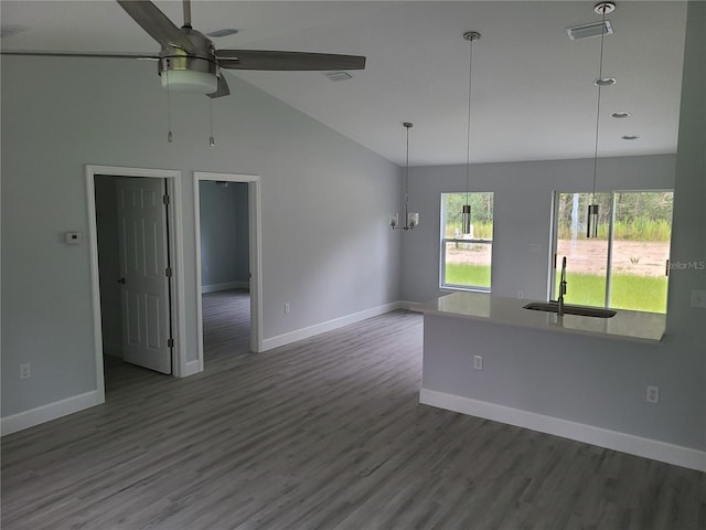 4333 SW 157th Ter, Ocala, FL 34481 - empty room featuring a sink, baseboards, ceiling fan, wood finished floors, and high vaulted ceiling