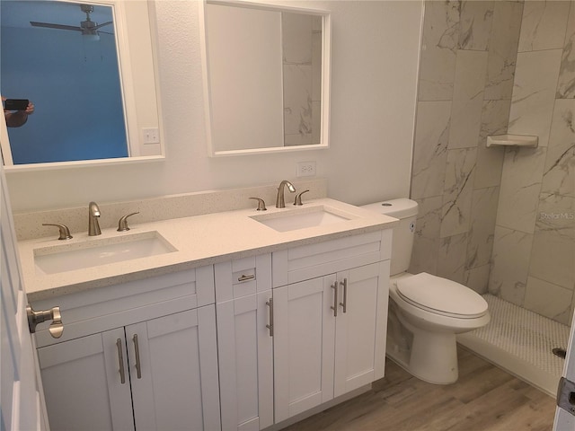 4333 SW 157th Ter, Ocala, FL 34481 - full bath with toilet, double vanity, wood finished floors, a marble finish shower, and ceiling fan