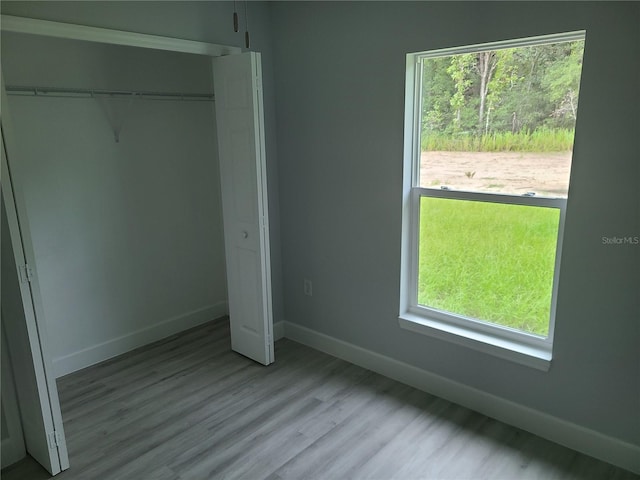 4333 SW 157th Ter, Ocala, FL 34481 - unfurnished bedroom with a closet, baseboards, and wood finished floors