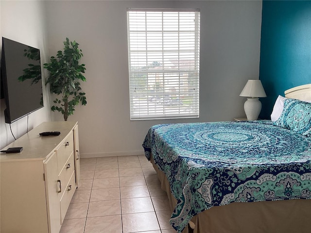 2305 Butterfly Palm Way Unit 304, Kissimmee, FL 34747 - bedroom with baseboards and light tile patterned floors